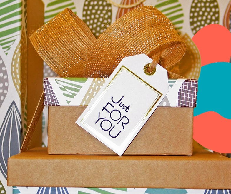 3 wrapped gifts for employees with a thank you card