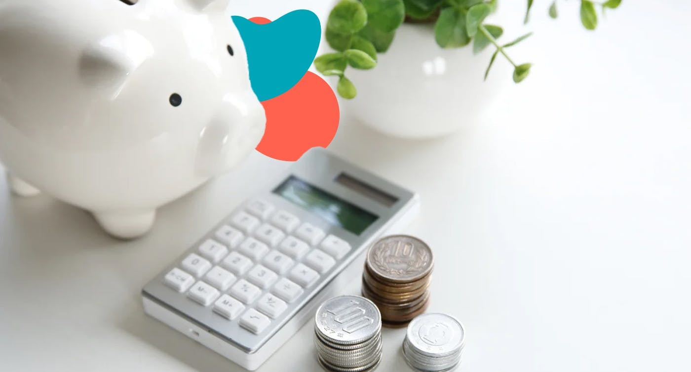 a piggy bank, a calculator and some coins