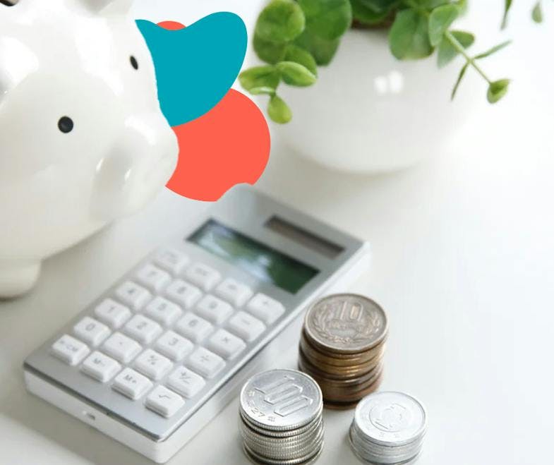a piggy bank, a calculator and some coins