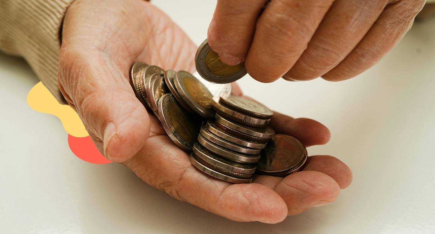 A pensioner hand holding some money